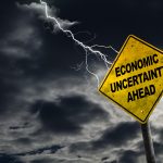 Economic Uncertainty Ahead Sign With Stormy Background