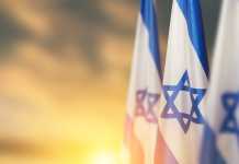 Deadliest Day for Jews Since the Holocaust Spurs a Crisis of Confidence in the Idea of Israel – And Its Possible Renewal Israel flags with a star of David over cloudy sky background on sunset. Banner with place for text.