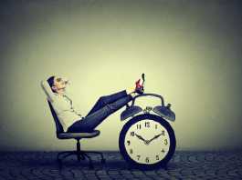 The Millions of People Not Looking for Work in the UK may be Prioritising Education, Health and Freedom woman sitting and relaxing on the chair with the alarm clock on the side