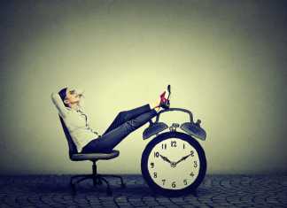 The Millions of People Not Looking for Work in the UK may be Prioritising Education, Health and Freedom woman sitting and relaxing on the chair with the alarm clock on the side