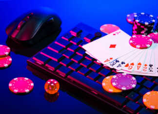 How Live Dealer Games Are Changing the Online Casino Experience A vibrant arrangement of poker chips and playing cards on a gaming keyboard with a mouse at an online casino setup during the evening