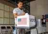 What Happens Before a Voter Reaches the Ballot? Voter Decision-Making - man placing his vote ballot