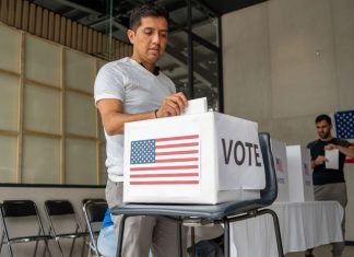 What Happens Before a Voter Reaches the Ballot? Voter Decision-Making - man placing his vote ballot