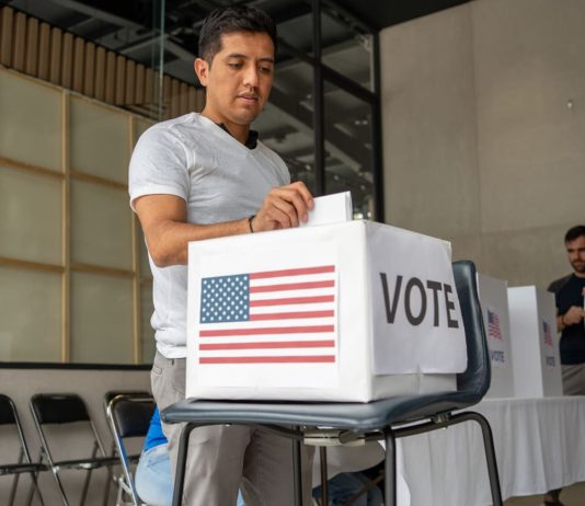 What Happens Before a Voter Reaches the Ballot? Voter Decision-Making - man placing his vote ballot