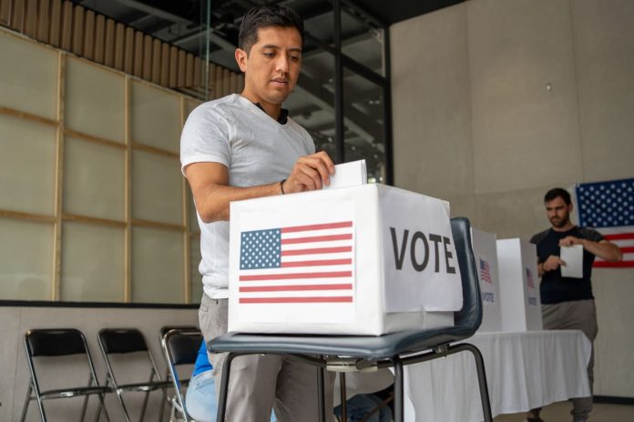 iStock-2160818114 (1) Voter Decision-Making - man placing his vote ballot